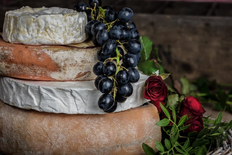 rounds of Artisanal Cheese with grapes and roses