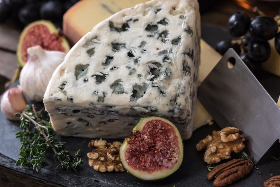 charcuterie plate with brie chess, olives, and walnut