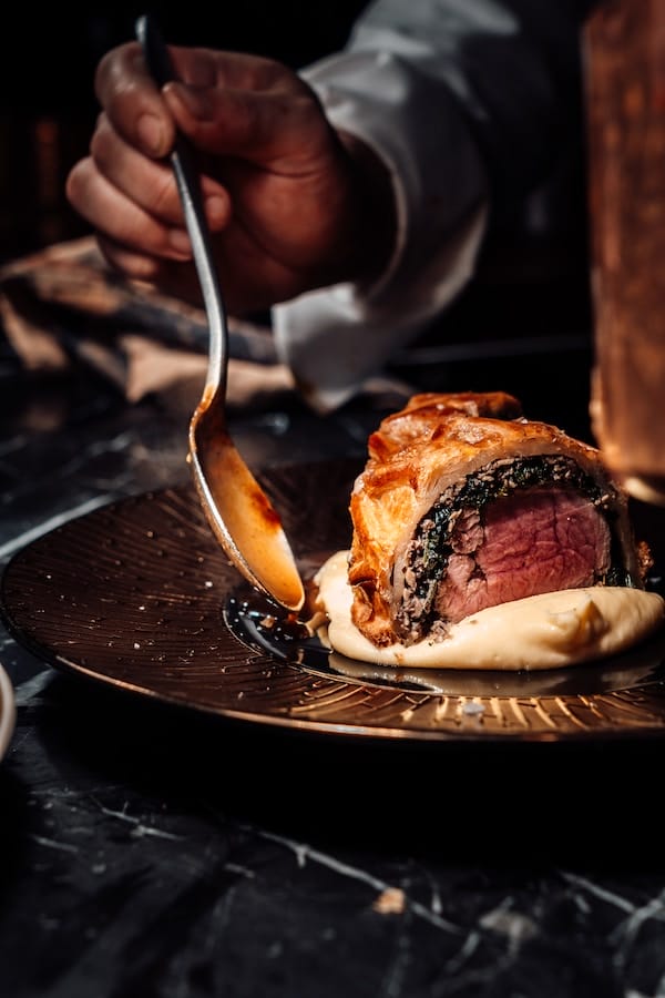 a chef preparing a plate of Gourmet Cuisine