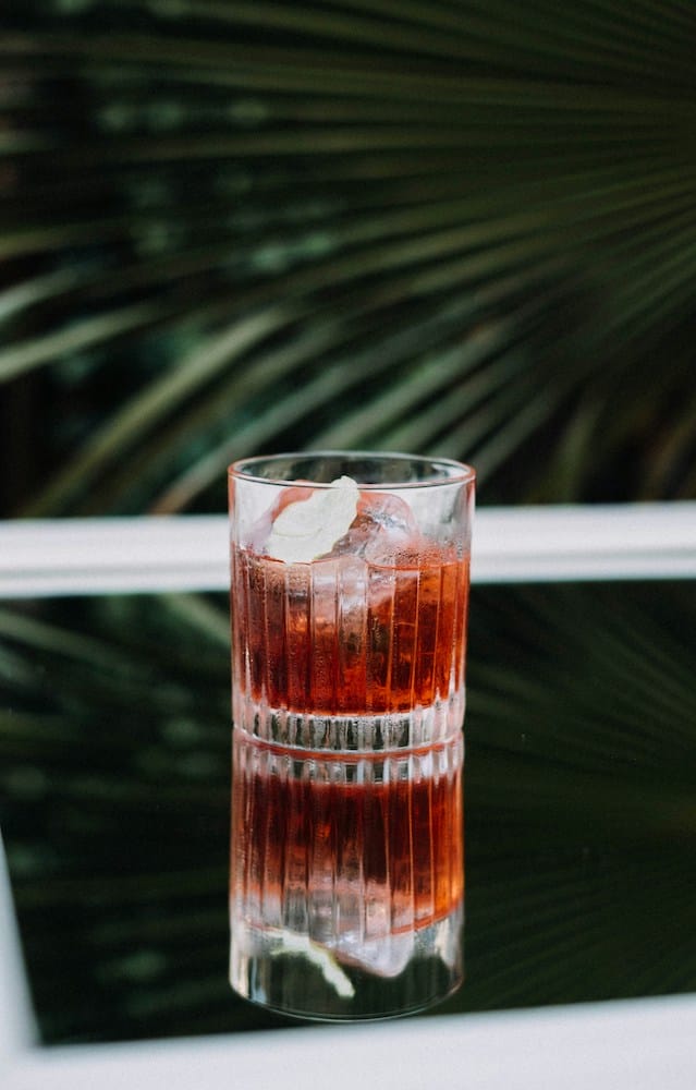 a red cocktail with ice