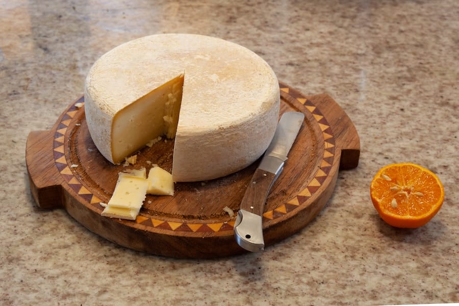 a cheese plate with Artisanal Cheese round
