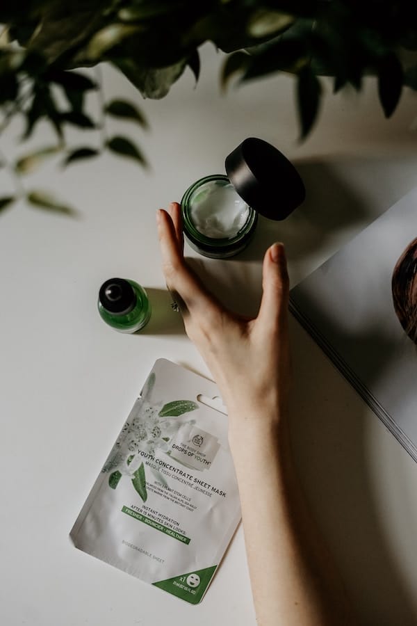 luxury skincare cream box opened by a hand