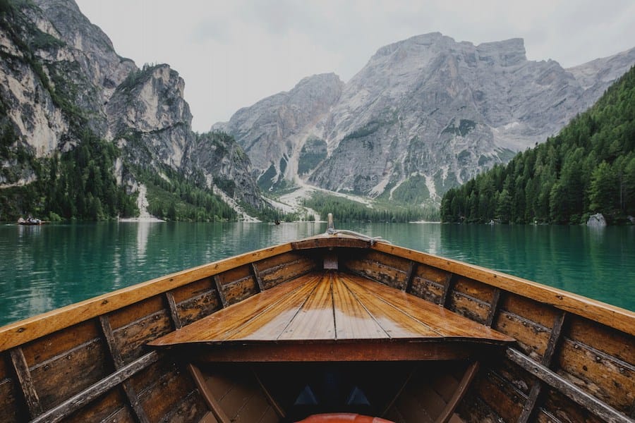 a view of lake from a wooden boat, illustrating slow travel